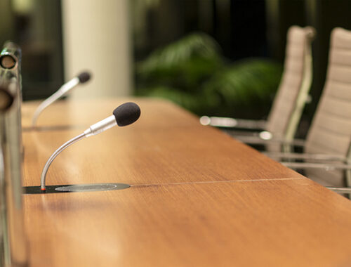 Empty chairs at a conference table